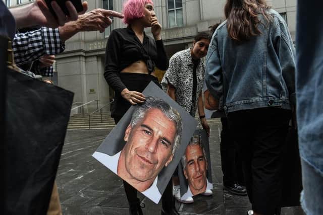 A protest group called "Hot Mess" hold up signs of Jeffrey Epstein in front of the Federal courthouse in New York. Picture: Stephanie Keith/Getty Images