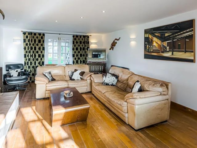 The living room features a cosy fireplace
