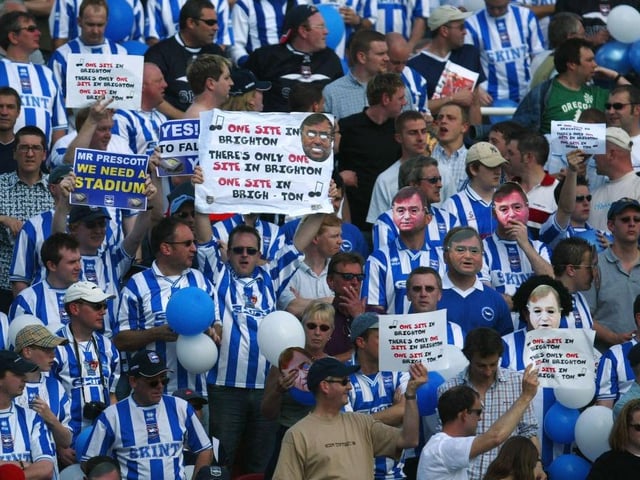Brighton and Hove Albion fans hold up posters and wear masks of MP John Prescott in protest over needing a stadium during the Nationwide Division Two Play-off First Leg match between Swindon Town and Brighton and Hove Albion at the County Ground on May 16, 2004.