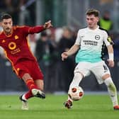 Lorenzo Pellegrini of AS Roma passes the ball whilst under pressure from Billy Gilmour of Brighton & Hove Albion during the UEFA Europa League round of 16 first leg match
