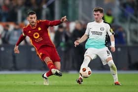 Lorenzo Pellegrini of AS Roma passes the ball whilst under pressure from Billy Gilmour of Brighton & Hove Albion during the UEFA Europa League round of 16 first leg match