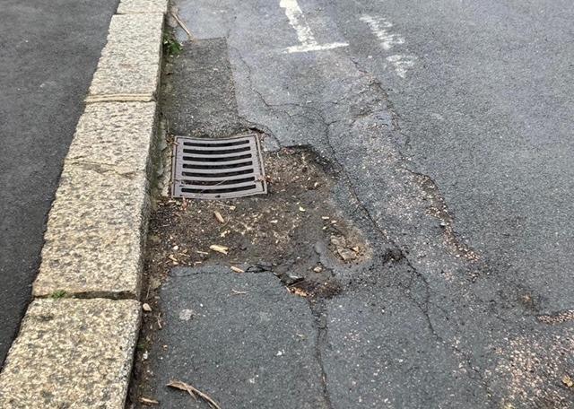 Damaged kerb stones and road surface