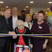 Ethel Thomas pictured centre and the Deputy Mayor (left centre) cutting the ribbon to open the home officially. 