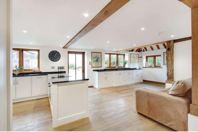 The dual aspect kitchen/breakfast room has an excellent range of bespoke painted wood cabinets under black granite worktops, a four oven oil fired Aga, separate electric oven and hob, integrated dishwasher and fridge/freezer, and a space for table and chairs or a sofa
