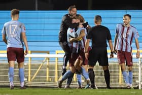 Chris Agutter and his Hastings United players celebrate their late salvation at Concord Rangers | Picture: Scott White