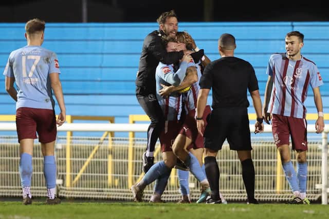 Chris Agutter and his Hastings United players celebrate their late salvation at Concord Rangers | Picture: Scott White