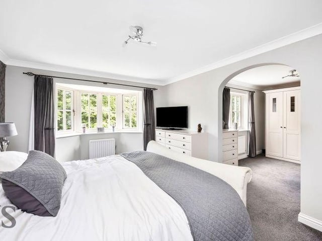 The luxurious primary suite is a true retreat, complete with spacious dressing room