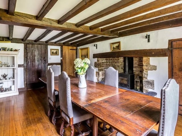 The drawing room and dining room both have original inglenook fireplaces with wood burners and views across the east walled garden.