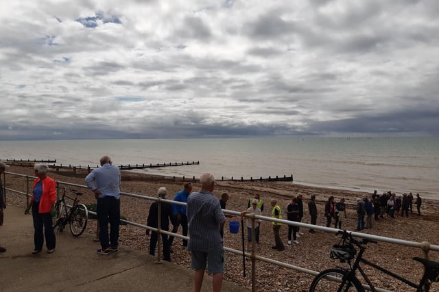 A bucket chain of volunteers from Ferring History Group and Ferring Conservation Group, including Worthing West MP Sir Peter Bottomley, form a bucket chain to bail out nine inches of water from the Ferring pillbox