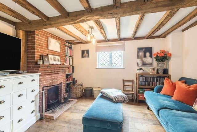 The cosy sitting room has an open fire