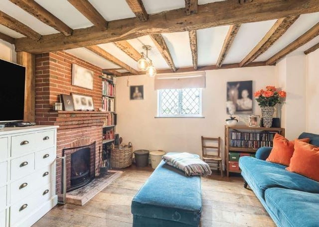 The cosy sitting room has an open fire