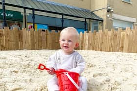 Toddler enjoying the sand pit in 2022