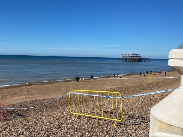 Police officers have taped off a section of Brighton beach after the discovery of a 'suspected mine'