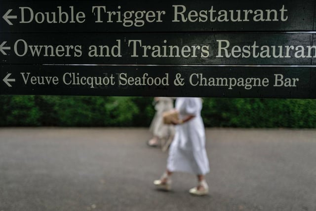 CHICHESTER, ENGLAND - AUGUST 02: Off for food and drink at Goodwood Racecourse on August 02, 2023 in Chichester, England. (Photo by Alan Crowhurst/Getty Images):Images from a murky second day at Glorious Goodwood by Alan Crowhurst of Getty and Clive Bennett
