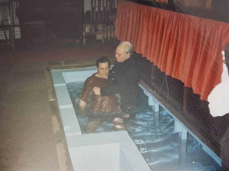 Towel at the ready as the baptism takes place