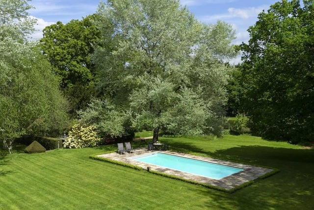 A well screened swimming pool and a tennis court are within the gardens