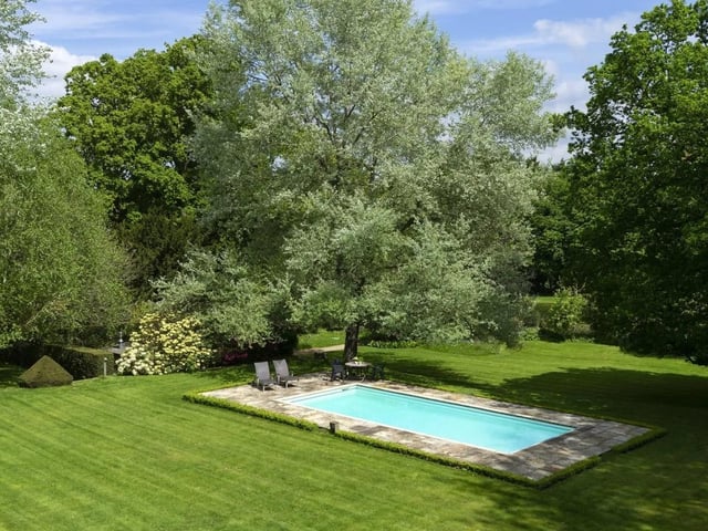 A well screened swimming pool and a tennis court are within the gardens