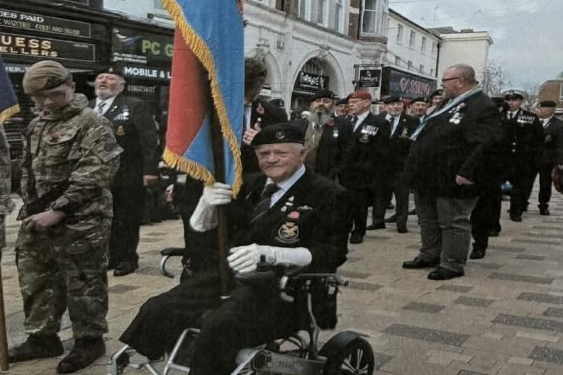 Kevin Beevis carrying the standard during the Remembrance Day parade