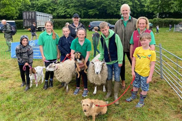 Chrissy Wells and Caroline Tasker with farm school students and four-legged friends