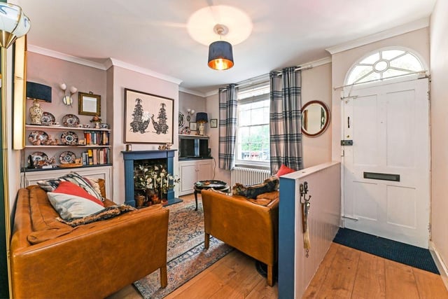 The property boasts a cosy living room with a blocked-off feature fireplace.