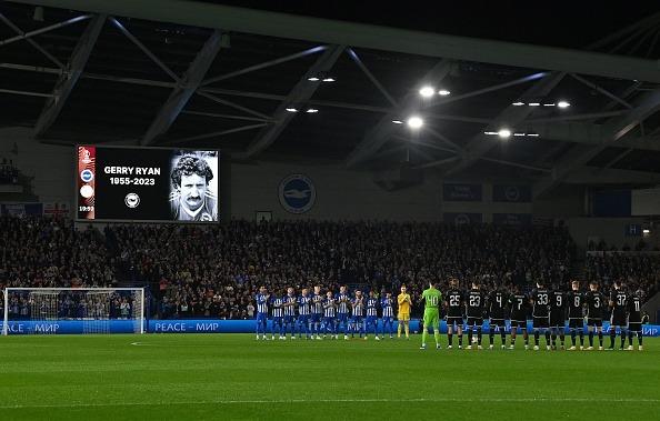 Players observe a minute's applause for former Brighton player Gerry Ryan