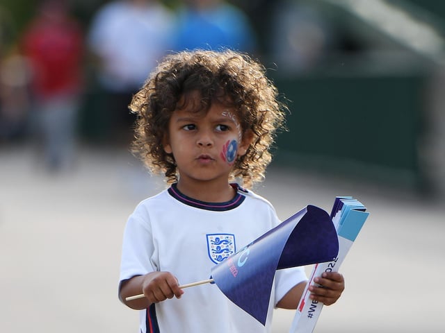 A young England fan heads to the stadium.