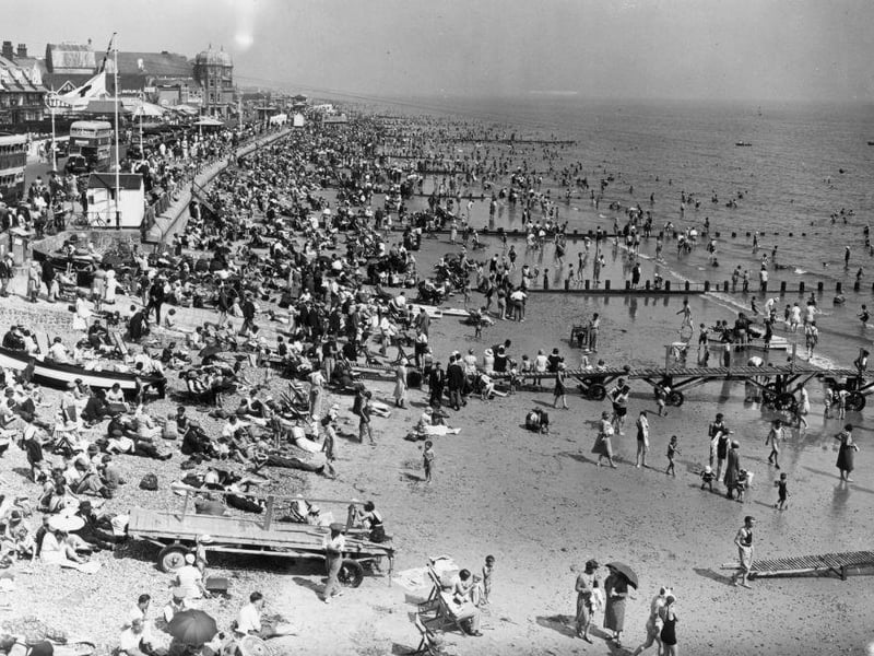 A view from the pier at Bognor Regis during a heatwave showing the crowded beach on 7th August 1933: