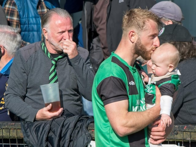 Burgess Hill Town players, fans and staff celebrate surviving in the Isthmian south east division at the end of their 0-0 draw with Beckenham