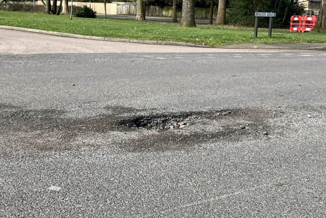 One of a number of deep potholes in Church Road, Roffey, Horsham