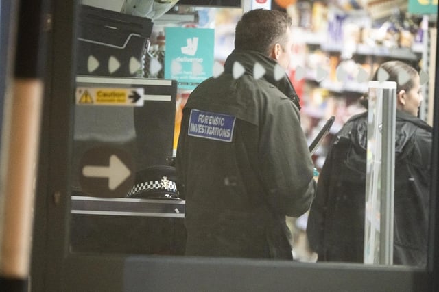 Police at the scene of the armed robbery in Crawley. Picture by Eddie Mitchell