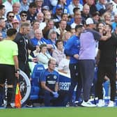 Juergen Klopp, Manager of Liverpool, attempts to calm down Roberto De Zerbi, Manager of Brighton & Hove Albion, as he argues with the Fourth Official