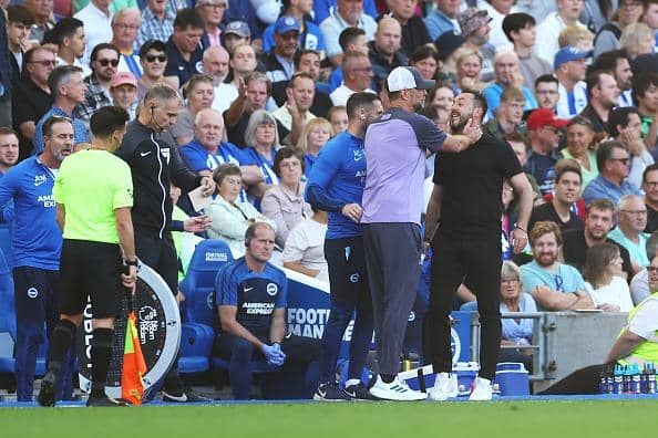 Juergen Klopp, Manager of Liverpool, attempts to calm down Roberto De Zerbi, Manager of Brighton & Hove Albion, as he argues with the Fourth Official