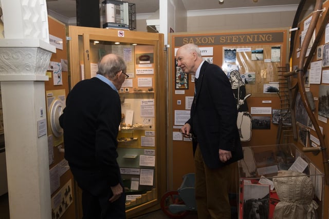Andy Bliss, High Sheriff of West Sussex, and Chris Tod of Steyning Museum view the archaealogical finds cabinet. Copyright Nick Quinn 2024