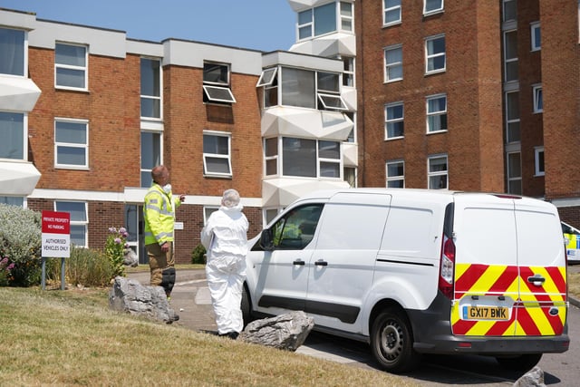A fire investigation continued on Thursday, with forensic officers pictured at the scene.