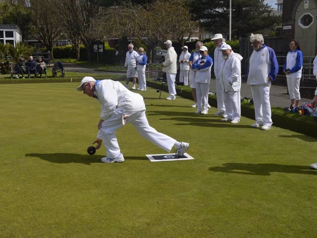 Captain Jim Grey throws the first bowl.