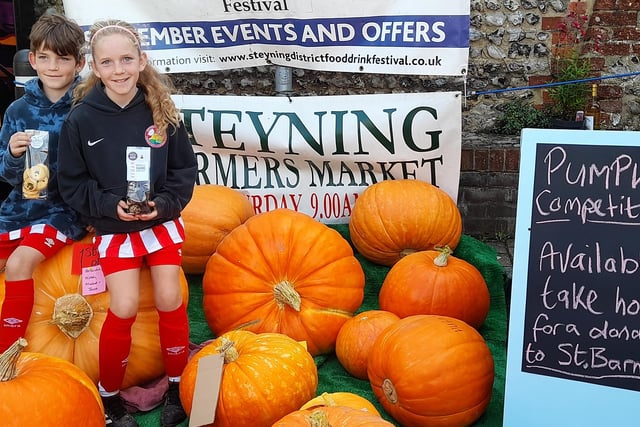 Two of the first prize winners on their champion pumpkin
