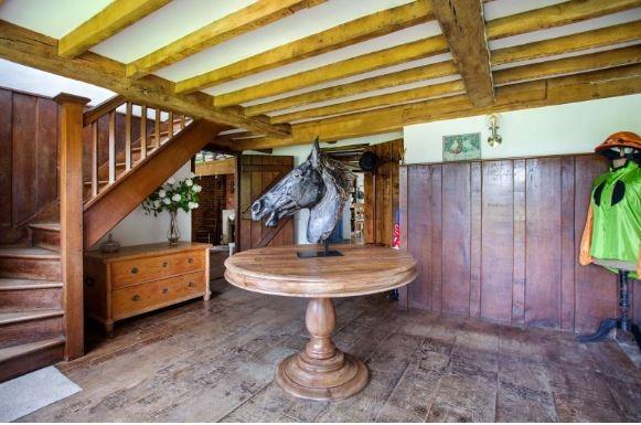 The reception hall epitomises the style of the house with part panelled walls and an impressive wooden staircase rising to the first floor