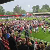 Crawley Town fans on the pitch after the game