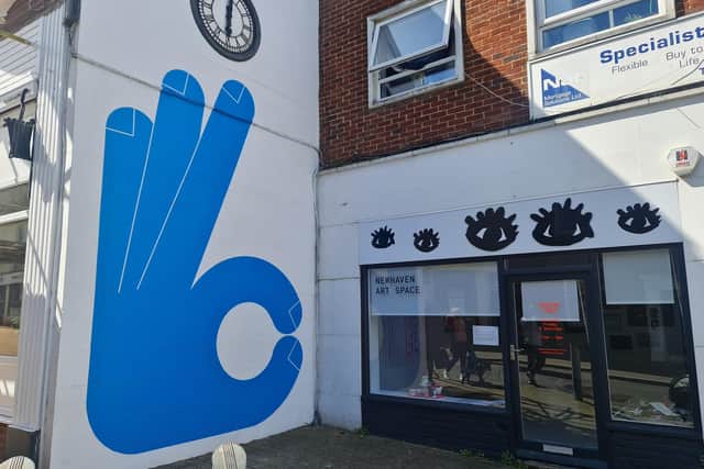 The first mural of a blue hand by Paul Farrell was installed by Many Hans Studio on Wednesday, April 10, next to Newhaven Art Space on the High Street. Image: Izzi Vaughan