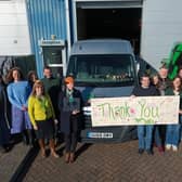 Foodbank team hold gratitude banner made by clients needing to use the foodbank outside the Brampton Road warehouse