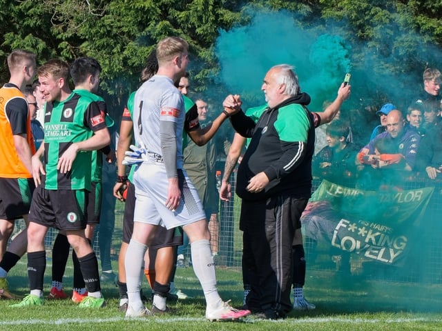 Burgess Hill Town players, fans and staff celebrate surviving in the Isthmian south east division at the end of their 0-0 draw with Beckenham