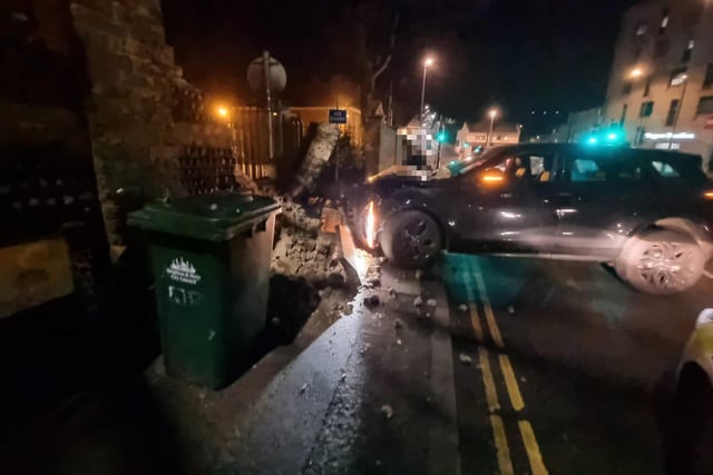 Police were spotted next to a damaged car and collapsed wall in Brighton on Saturday, February 18