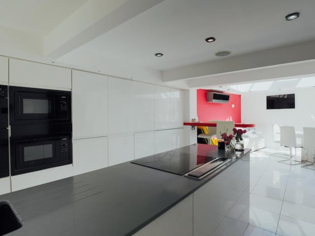 A second look at the classy kitchen which, like all the rooms in the house, so so well presented. The dining room is in the background.