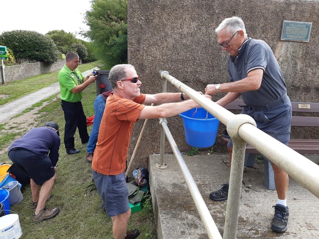 A bucket chain of volunteers from Ferring History Group and Ferring Conservation Group, including Worthing West MP Sir Peter Bottomley, form a bucket chain to bail out nine inches of water from the Ferring pillbox