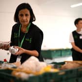 A member of staff sorts through food items inside a foodbank in Hackney, north-east London. (Photo by Daniel Leal/AFP via Getty Images)