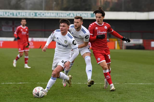 Tom Nichols battles for possession with Liam Cooper and Jamie Shackleton of Leeds United during the FA Cup Third Round match between Crawley Town and Leeds United at The Peoples Pension Stadium on January 10, 2021.