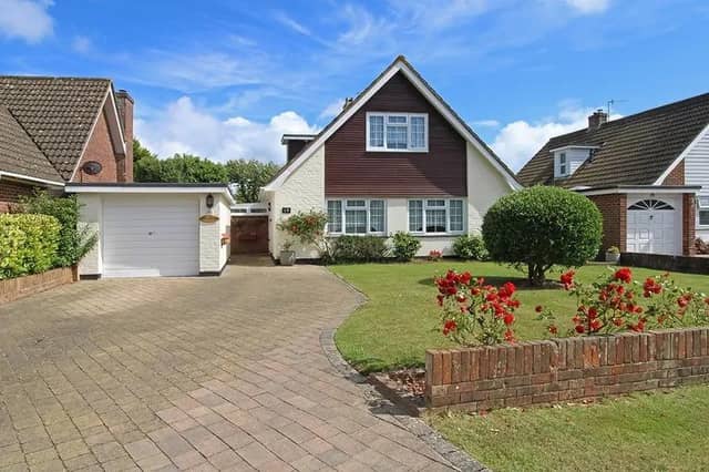 A generous front drive provides additional parking space.