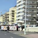 Protestors marching behind a 'We are all migrants' banner near Hove lawns on Saturday, October 17. Photo: Eddie Mitchell
