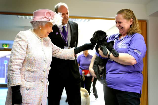The Queen visited Canine Partners, Mill Lane, Heyshott, Midhurst. Ruth Narracott holding Flint. Pic Steve Robards SR1728725