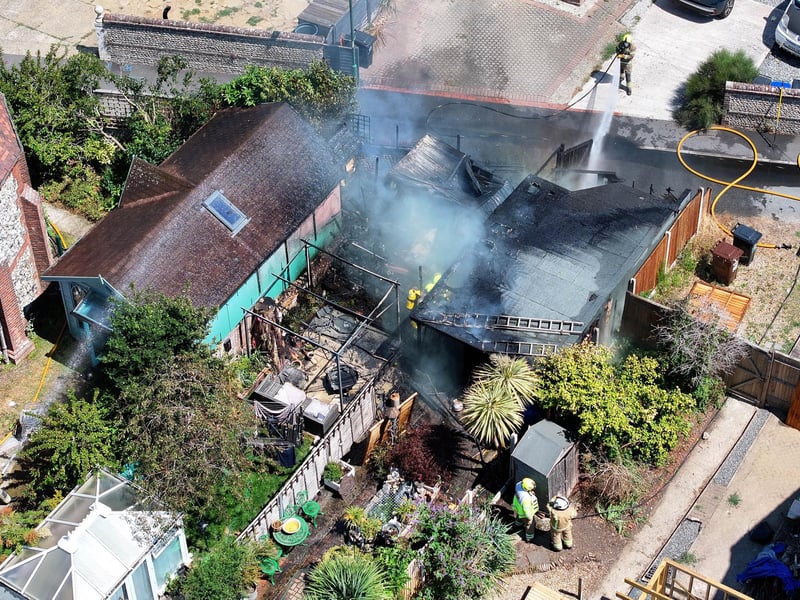 Firefighters tackle a blaze that destroyed two sheds, on Beaconsfield Road